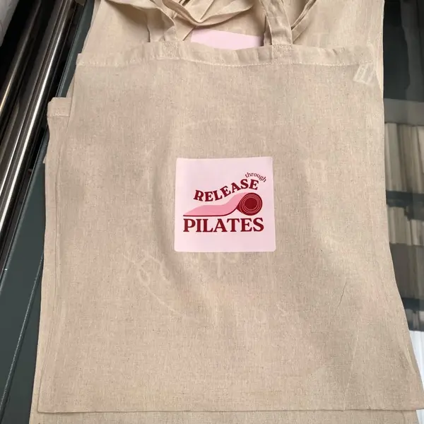 Custom-printed reusable tote bags featuring white personalised branding