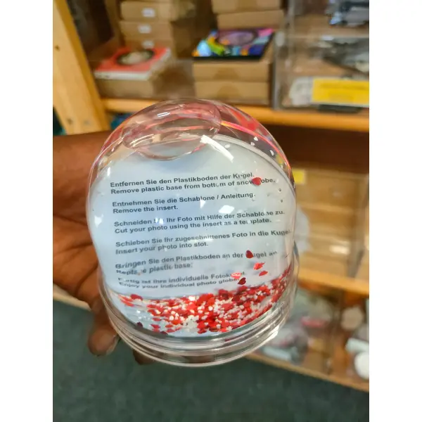 Personalised photo globe with red and white heart-shaped glitter