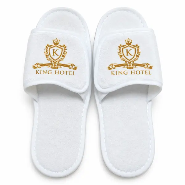 Personalised white open-toe hotel slippers with custom gold printing